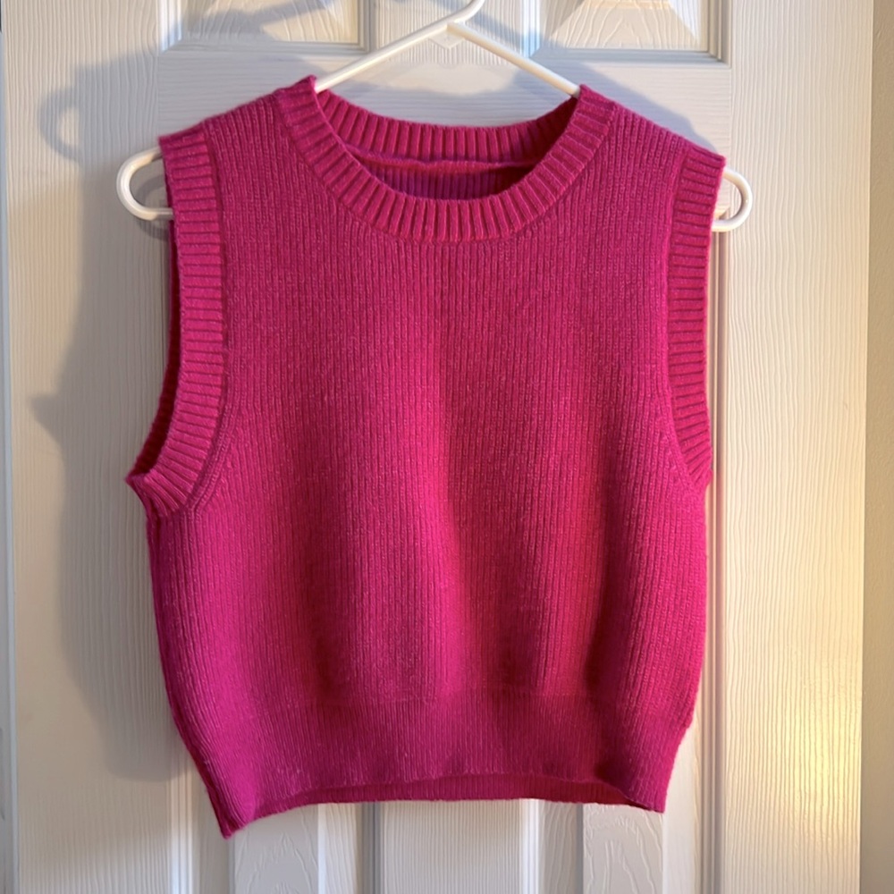 Hot pink sleeveless sweater.